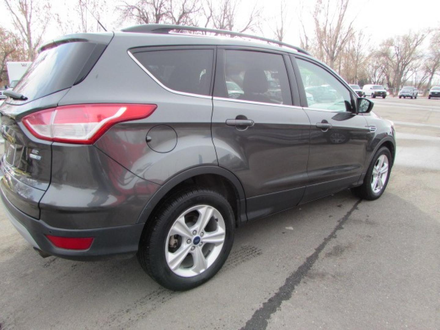 2015 Gray /Tan Ford Escape SE (1FMCU9G96FU) with an 2.0 I4 Ecoboost turbo engine engine, 6 speed automatic transmission, located at 4562 State Avenue, Billings, MT, 59101, (406) 896-9833, 45.769516, -108.526772 - 2015 Ford Escape SE 4WD 2.0 Ecoboost Turbo 4 cylinder engine - 6 speed automatic transmission - 4WD - 151,468 miles $256 per month - payment example based on $1000 cash or trade down - 36 months at 7.99 percent APR - on approved credit SE package - air conditioning - tilt and steering wheel - Photo#3